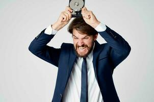 a man in a suit with a hard drive information recovery emotions photo