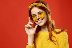 cheerful woman in yellow glasses sweater hipster fashion retro style photo