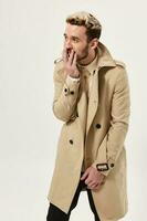 man with full hair in coat autumn style studio isolated background photo