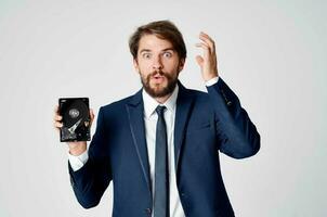 emotional business man with hard drive on computer technology photo