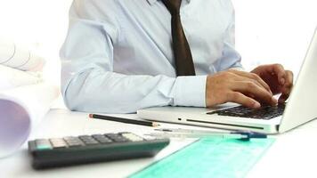 Businessman working at office desk, architect man in suit typing on laptop, architectural business, selective focus video