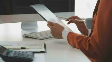 Financial analysts analyze business financial reports on a digital tablet planning investment project during a discussion at a meeting of corporate showing the results of their successful teamwork. video