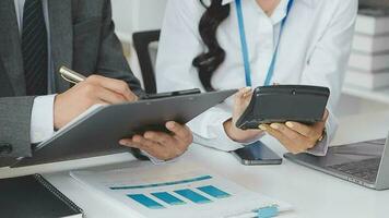 Financial analysts analyze business financial reports on a digital tablet planning investment project during a discussion at a meeting of corporate showing the results of their successful teamwork. video