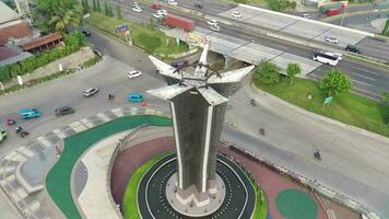 4K footage aerial view of Tugu Pancakarsa in the morning at the crossroads side by side with the toll road. video