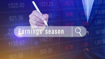 Earnings season Hand touching of written in search bar with the financial data visible in the background,  Reports Stock Market Ticker Words photo