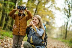 Mother and son hiking in the forest photo