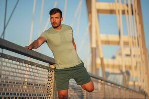 A man in a green t-shirt doing exercises photo