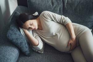 Pregnant woman sleeping on the couch. photo