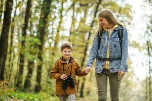 Mother and son hiking in the forest photo