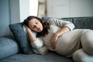 Pregnant woman sleeping on the couch. photo