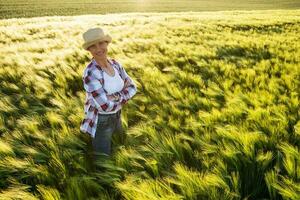 Farmer woman outdoors by the barley crop photo