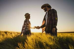 Farmer couple on their land and plantation photo