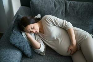 Pregnant woman not feeling well at home. photo