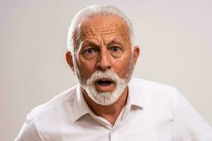 Portrait of a senior man in a white shirt photo