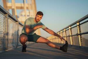 A man in a green t-shirt doing exercises photo