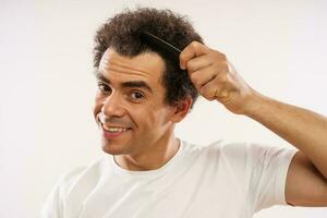 Afro man brushing hair photo
