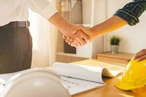 Successful team building asian young male, man or builder group handshake together at office after home project done, good deal. Happy business people, Worker meeting, shaking hands and success. photo