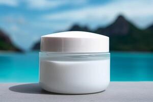 Blank, unbranded cosmetic cream jar outdoors, with blue water in the background. Skin care product presentation. Skincare, beauty. Jar with copy space, moisturizer. Lagoon, beach. . photo