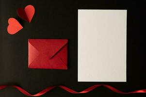 Red Heart paper and blank with note card on wall background photo