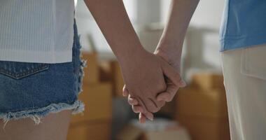 Two young women hand in hand at new home photo