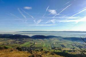 wonderful view to dense fog at the horizon with blue sky and sunshine photo