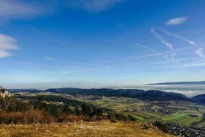 view to dense fog at the horizon with blue sky and sunshine photo