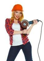 Female construction worker in a hard hat with angle grinder photo