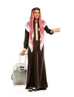 Young smiling arab with a suitcase isolated on white photo