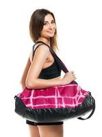 Portrait of attractive caucasian smiling woman with sports bag photo