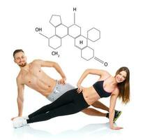 Athletic attractive couple - man and woman doing fitness exercises with the chemical formula on background - concept of healthy life photo