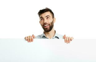 A young bearded man showing blank signboard, isolated over white photo