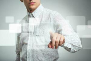 Businessman pressing application button on computer with touch screen photo