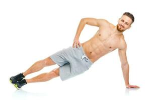 Sport attractive man doing fitness exercises on the white photo