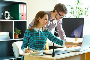 Beautiful young woman and man working from home photo