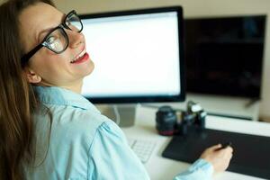 Beautiful young woman working from home photo