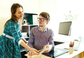 Young woman and man working from home - modern business concept photo