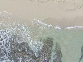 aerial top down view of beautiful sand beach and coral reefs photo