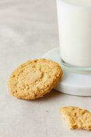 Glass of fresh milk with oatmeal cookies photo