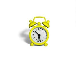 The alarm clock is bright yellow on a white background. photo