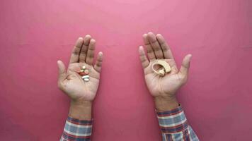 Holding Hearing aid equipment and medical pill on red , video