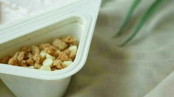 fresh yogurt in a plastic container and spoon on table video