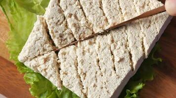 top view of slice of tofu on a chopping board on table video