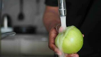 fresh apple washing with hand. video