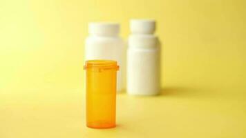 Empty medical pill container on yellow background video