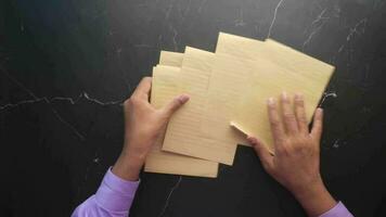 Top view of young man hand on blank paper on table video