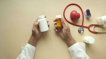 Top view of doctor holding medical pill container video