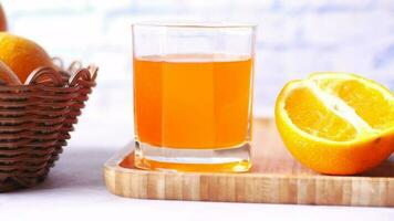 orange juice in glass on table video