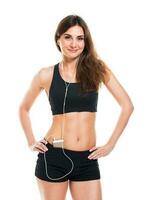 Beautiful slim woman listening to music while exercising photo