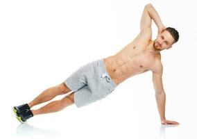 Sport attractive man doing fitness exercises on the white photo