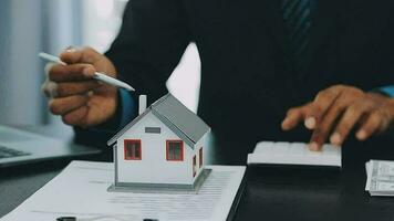 Female woman hands holding home model, small miniature white toy house. Mortgage property insurance dream moving home and real estate concept video